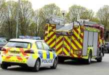 securing-unstable-shop-sign-and-loose-power-cable-during-storm-darragh-firefighters-rescue-efforts